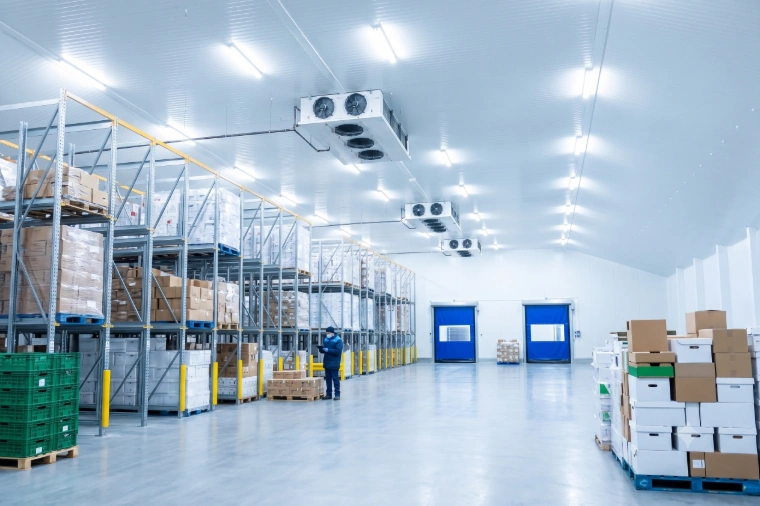 Refrigerated warehouse floor with racked pallets and ceiling evaporator units